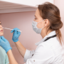 Medical professional taking nasopharynx sample from young girl